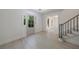 Bright foyer with light wood floors, staircase, and sidelight by the front door at 1348 Timberland Se Dr, Marietta, GA 30067