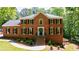 Charming brick two-story home with a well-manicured lawn and landscaping at 1348 Timberland Se Dr, Marietta, GA 30067