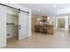 Open-concept kitchen with modern appliances, an island with stool seating, and a sliding pantry door at 1348 Timberland Se Dr, Marietta, GA 30067