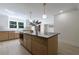 Large kitchen island with seating, storage, and stylish pendant lighting at 1348 Timberland Se Dr, Marietta, GA 30067