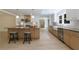 Modern kitchen with an island, stainless steel appliances, light wood floors and views into the living room at 1348 Timberland Se Dr, Marietta, GA 30067