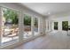 Sunroom with large windows offering a view of the pool area, complemented by hardwood floors and white trim at 1348 Timberland Se Dr, Marietta, GA 30067