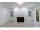 Bright living room features a fireplace, recessed lights, and large windows with views of the surrounding trees at 1348 Timberland Se Dr, Marietta, GA 30067
