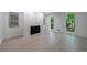 Bright living room features a fireplace, recessed lights, and large windows with views of the surrounding trees at 1348 Timberland Se Dr, Marietta, GA 30067