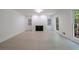 Bright living room features a fireplace, recessed lights, and large windows with views of the surrounding trees at 1348 Timberland Se Dr, Marietta, GA 30067
