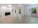Bright living room with a fireplace, white walls, light hardwood floors, and a door to the exterior at 1348 Timberland Se Dr, Marietta, GA 30067