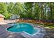 Beautiful in-ground pool with mature trees and landscaping surrounding the property at 1348 Timberland Se Dr, Marietta, GA 30067