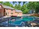A large, in-ground pool is surrounded by a spacious patio, perfect for outdoor entertaining and relaxation at 1348 Timberland Se Dr, Marietta, GA 30067