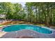 Serene in-ground pool nestled within a wooded backyard, offering a private and refreshing escape at 1348 Timberland Se Dr, Marietta, GA 30067