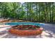 Beautiful in-ground pool surrounded by lush landscaping, perfect for summer fun at 1348 Timberland Se Dr, Marietta, GA 30067