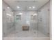 Large glass-enclosed shower featuring multiple showerheads and a built-in bench at 1348 Timberland Se Dr, Marietta, GA 30067