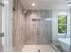 Glass enclosed shower with beige tile and a built-in niche at 1348 Timberland Se Dr, Marietta, GA 30067