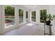 Bright sunroom with large windows overlooking a backyard pool and green space at 1348 Timberland Se Dr, Marietta, GA 30067