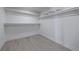A well-organized, all-white walk-in closet with shelving and hardwood floors at 1348 Timberland Se Dr, Marietta, GA 30067