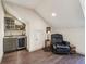 Wet bar area with storage cabinets, a countertop, a mini-fridge, and a stylish chair at 306 Nottaway Ln, Alpharetta, GA 30009