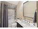 Well-lit bathroom with a tub-shower, modern fixtures, and a granite countertop at 306 Nottaway Ln, Alpharetta, GA 30009