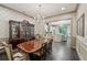 Elegant dining room with a decorative chandelier, china cabinet, and adjacent kitchen at 306 Nottaway Ln, Alpharetta, GA 30009