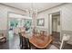 Formal dining room featuring a chandelier, hardwood floors, and views into the living spaces at 306 Nottaway Ln, Alpharetta, GA 30009