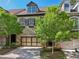 Charming townhome with stone accents, a two-car garage, and lush landscaping, creating curb appeal at 306 Nottaway Ln, Alpharetta, GA 30009