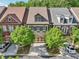 Well-maintained townhome featuring a symmetrical facade, a two-car garage, and neat landscaping at 306 Nottaway Ln, Alpharetta, GA 30009