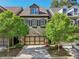 Charming townhome featuring a stone and brick facade, a two-car garage, and neatly manicured landscaping at 306 Nottaway Ln, Alpharetta, GA 30009