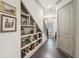 Inviting hallway featuring custom built-in shelving, hardwood floors, and stylish decor at 306 Nottaway Ln, Alpharetta, GA 30009