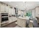 Gourmet kitchen with stainless steel appliances, white cabinets, a stylish island, and plenty of counter space at 306 Nottaway Ln, Alpharetta, GA 30009