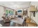 Bright living room with a stone fireplace, custom built-ins, hardwood floors, and elegant decor at 306 Nottaway Ln, Alpharetta, GA 30009