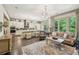 Open floor plan featuring hardwood floors, a fireplace, and seamless connection to the modern kitchen at 306 Nottaway Ln, Alpharetta, GA 30009