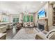Open-concept living room boasts a fireplace, hardwood floors, and is adjacent to a modern kitchen at 306 Nottaway Ln, Alpharetta, GA 30009