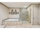 Charming main bathroom featuring a soaking tub, glass-enclosed shower, and neutral tones at 306 Nottaway Ln, Alpharetta, GA 30009