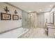 Luxurious primary bathroom featuring a soaking tub, glass-enclosed shower, and vanity at 306 Nottaway Ln, Alpharetta, GA 30009