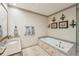 Comfortable primary bathroom featuring a soaking tub, vanity, and glass-enclosed shower at 306 Nottaway Ln, Alpharetta, GA 30009