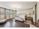 Spacious main bedroom with a chandelier, hardwood floors, and natural light from windows at 306 Nottaway Ln, Alpharetta, GA 30009