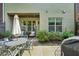 Outdoor patio with wrought-iron furniture, an umbrella, and views of the home at 306 Nottaway Ln, Alpharetta, GA 30009