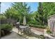 Outdoor patio with wrought-iron furniture, a grill, and mature landscaping at 306 Nottaway Ln, Alpharetta, GA 30009