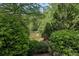 Serene pond surrounded by lush greenery and trees, providing a peaceful view at 306 Nottaway Ln, Alpharetta, GA 30009