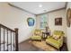 Cozy sitting area with hardwood floors, two cushioned chairs, and a decorative rug at 306 Nottaway Ln, Alpharetta, GA 30009