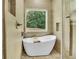 The bathroom features a standalone tub with a window view and a glass shower at 6022 Fieldcrest Dr, Morrow, GA 30260