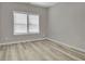 This bedroom features a large window, modern flooring, and neutral-colored walls at 6022 Fieldcrest Dr, Morrow, GA 30260