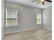This bedroom features two windows, modern flooring, and a ceiling fan at 6022 Fieldcrest Dr, Morrow, GA 30260