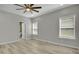 This bedroom features two windows, modern flooring, and a ceiling fan at 6022 Fieldcrest Dr, Morrow, GA 30260