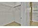 This closet features wire shelving, tile flooring, and leads to an en-suite bathroom at 6022 Fieldcrest Dr, Morrow, GA 30260