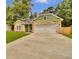 Beautiful home features a well-maintained lawn, stone accents, and an attached two car garage at 6022 Fieldcrest Dr, Morrow, GA 30260