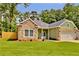 Charming home featuring stone accents, fresh green grass and a well-manicured yard at 6022 Fieldcrest Dr, Morrow, GA 30260