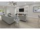 The living room has a ceiling fan, recessed lighting, hardwood flooring, an electric fireplace and built-in shelving at 6022 Fieldcrest Dr, Morrow, GA 30260