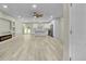 This open-concept living space has recessed lighting, a ceiling fan, built-in shelves, and an electric fireplace at 6022 Fieldcrest Dr, Morrow, GA 30260