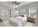 Main bedroom features neutral paint, ceiling fan, wood floors, and two large windows at 6022 Fieldcrest Dr, Morrow, GA 30260