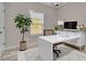 A staged office area with modern white desk, decor, and window at 6022 Fieldcrest Dr, Morrow, GA 30260