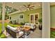 Outdoor patio with ceiling fan, modern seating, and manicured lawn at 6022 Fieldcrest Dr, Morrow, GA 30260